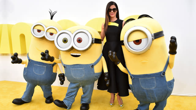 <strong>Sandra Bullock</strong> has fully embraced <em>Minions</em> mania. At least, if her high heels are any indication. At Saturday’s premiere of the <em>Despicable Me</em> spinoff, Bullock donned a pair of yellow, custom Minions pumps. But the shoes are more than a fashion statement -- she’s auctioning them off for charity! <strong> WATCH: Sandra says her son Louis has no idea his mom is an actress</strong> Getty Images “We’re going to give all the proceeds to Art + Practice, which is a non-profit organization here in L.A.,” Sandra told ET's <strong>Kevin Frazier</strong> about her heels, which were designed by Rupert Sanderson and retail for over $800. Art + Practice, according to their website, “encourages education and culture by providing life-skills training for foster young” for part of Los Angeles. They also curate free museum exhibits and art lectures for the community. Turns out those naughty minions can do some good too. <strong> NEWS: Sandra Bullock says 'Magic Mike XXL' trailer makes her 'ovulate'</strong> Bullock’s date for the premiere was her 5-year-old son, <strong>Louis</strong>, who was seeing the movie for the very first time. Sandra previously told us that Louis doesn’t even know she’s an actress, and claimed, in regards to her voicing <em>Minions</em>’ villainous Scarlett Overkill, “He’s not going to know it’s me.” But if all goes well and Louis likes the movie, she might be hearing her voice over and over and over again at home. “I hadn’t even thought of that until you brought that up,” she said, when reminded how many times she said her son made her watch <em>Despicable Me</em>. “Sometimes I look at these movies as nap time. Or get some work done or do some online shopping time. So maybe when my voice comes on, online shopping [...] I think that’s probably what is most likely going to happen.” <strong> WATCH: Sandra Bullock was one of the top 5 highest paid actresses in 2014</strong> Sandra also shared a touching message about her son, whom she adopted from New Orleans in 2010. “People go, ‘Your adopted son,’ and I go, ‘Please don’t say that. He is my son,’” she said. “I would give up my life for him. I mean, I have.” She continued, “I think times are changing. I know there’s a lot of ignorance and a lot of people just need time to catch up. You can’t get mad at that. All you can do is live by example. I look at the love that I have and I just wish for you that you can have that love too.” Now, find out how Sandra reacted to being named <em>People</em>’s Most Beautiful Woman: