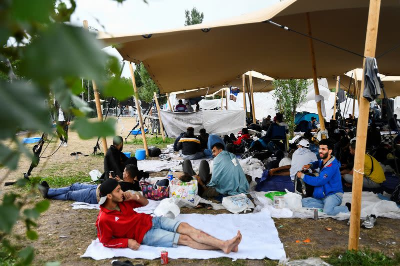 Refugees wait outside at the main reception centre for asylum seekers, in Ter Apel