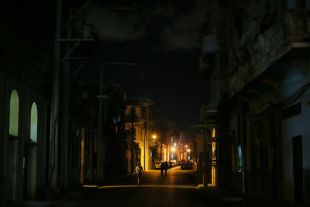 A woman walks along an empty street near the Malecon, following the announcement of the death of Cuban revolutionary leader Fidel Castro, in Havana, Cuba November 27, 2016. REUTERS/Carlos Barria