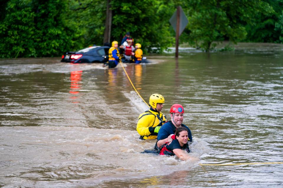 Commuters are rescued from a flooded car on Columbia Pike after a flash flood in Oakland Mills, Maryland, USA, 27 May 2018. The National Weather Service stated as much as 9.5 inches of rain fell in the area. Flash floods ravage Maryland, Oakland Mills, USA - 27 May 2018