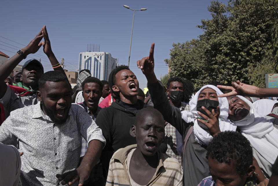 People chant slogans during a protest to denounce the October 2021 military coup, in Khartoum, Sudan, Tuesday, Jan. 4, 2022. Sudanese took to the streets in the capital, Khartoum, and other cities on Tuesday in anti-coup protests as the country plunged further into turmoil following the resignation of the prime minister earlier this week. (AP Photo/Marwan Ali)