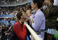 <p>United States’ Michael Phelps celebrates winning his gold medal in the men’s 200-meter butterfly with his mother Debbie, fiance Nicole Johnson and baby Boomer during the swimming competitions at the 2016 Summer Olympics, Tuesday, Aug. 9, 2016, in Rio de Janeiro, Brazil. (AP Photo/Matt Slocum) </p>