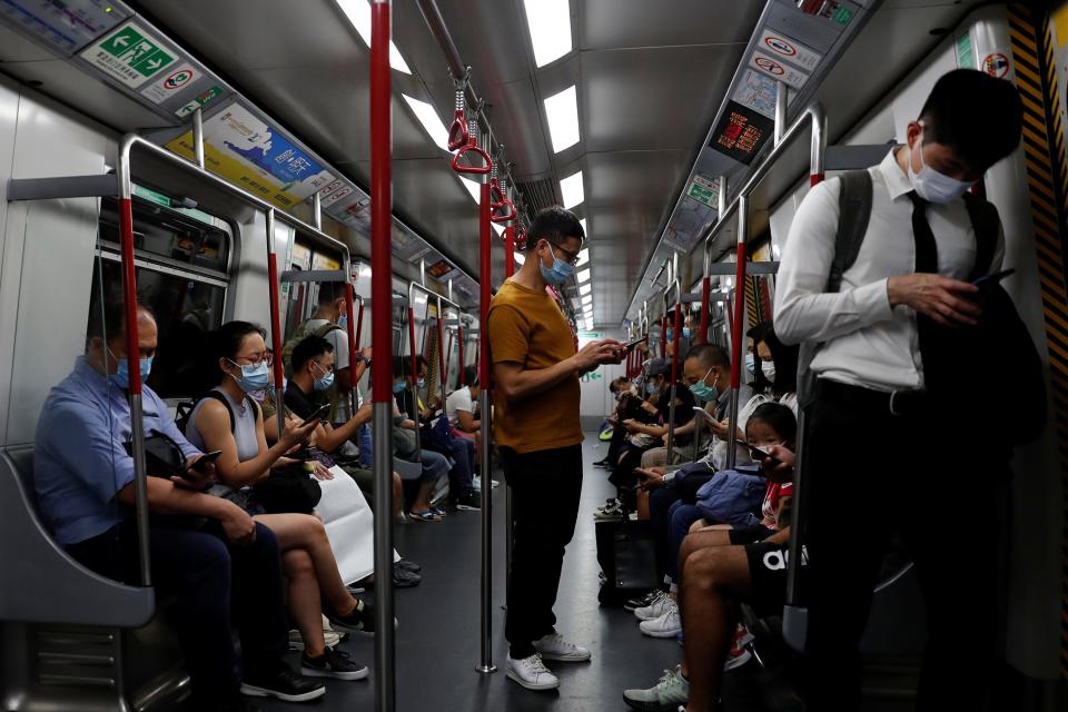 FILE PHOTO: Passengers wear surgical masks in an MTR train, following the outbreak of the coronavirus (COVID-19) in Hong Kong, China July 15, 2020. REUTERS/Tyrone Siu/File Photo