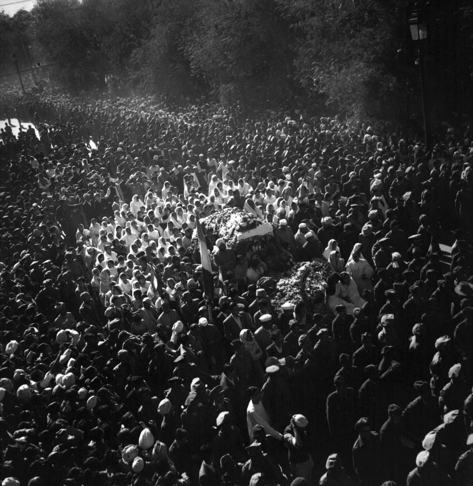 FILE - The body of assassinated Indian leader Mahatma Gandhi, covered with rose petals, is carried to the site of his cremation in New Delhi, Jan. 31, 1948. (AP Photo/Max Desfor, File)