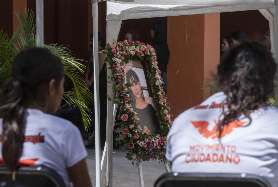 Friends mourn during the wake of mayoral candidate Alma Barragan in Moroleon, Mexico, Wednesday, May 26, 2021. Barragan was killed Tuesday while campaigning for the mayorship of the city of Moroleon, in violence-plagued Guanajuato state. (AP Photo/Armando Solis)