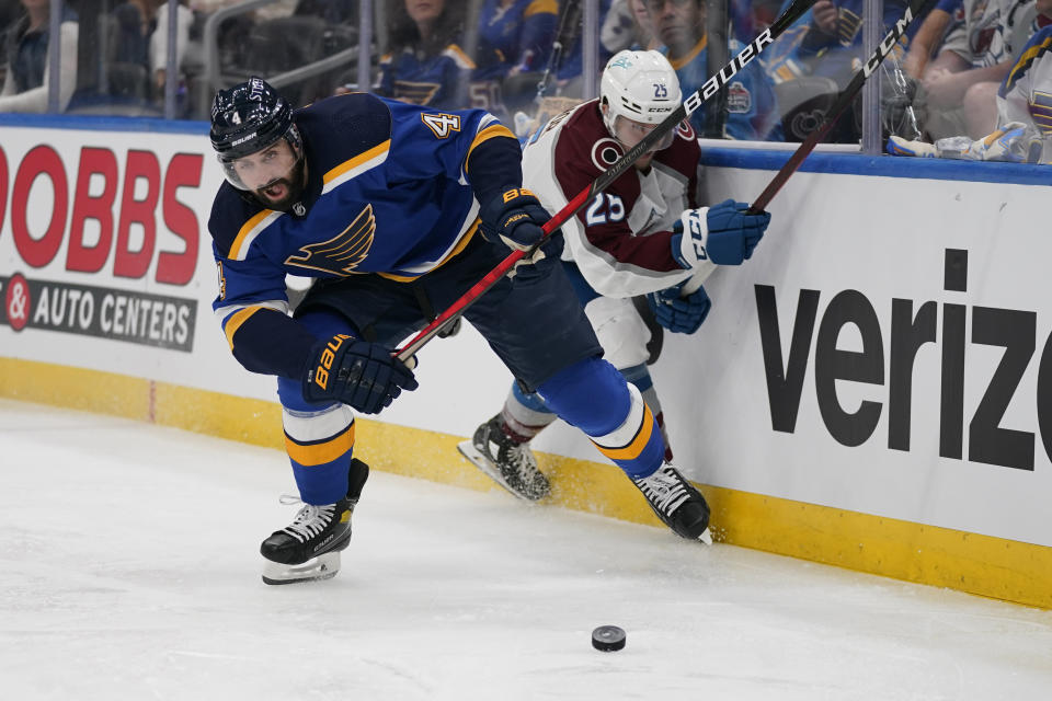 St. Louis Blues' Nick Leddy (4) and Colorado Avalanche's Logan O'Connor (25) chase after a loose puck during the third period in Game 3 of an NHL hockey Stanley Cup second-round playoff series Saturday, May 21, 2022, in St. Louis. (AP Photo/Jeff Roberson)