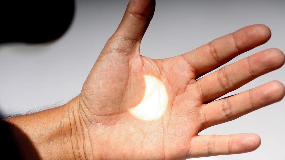 An image of the Sun is displayed during a solar eclipse on a hand in Ensenada, Baja California, Mexico, August 21, 2017. The city was not in the path of the total eclipse, so the Moon only partially obscured the Sun.  -Alejandro Zepeda/EPA/Shutterstock