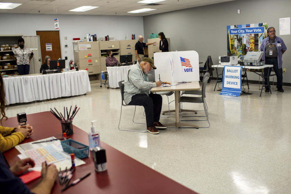 Voters cast their ballots on Friday, Sept. 23, 2022, in Minneapolis. With Election Day still more than six weeks off, the first votes of the midterm election were already being cast Friday in a smattering of states including Minnesota. (AP Photo/Nicole Neri)