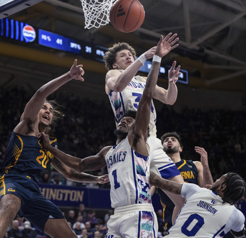 Washington center Braxton Meah, top middle, forward Keion Brooks Jr. (1) and guard Koren Johnson (0) work against California guard Jaylon Tyson, left, and forward Fardaws Aimaq, second from right, for a rebound during the second half of an NCAA college basketball game Saturday, Feb. 17, 2024, in Seattle. California won 82-80. (AP Photo/Stephen Brashear)