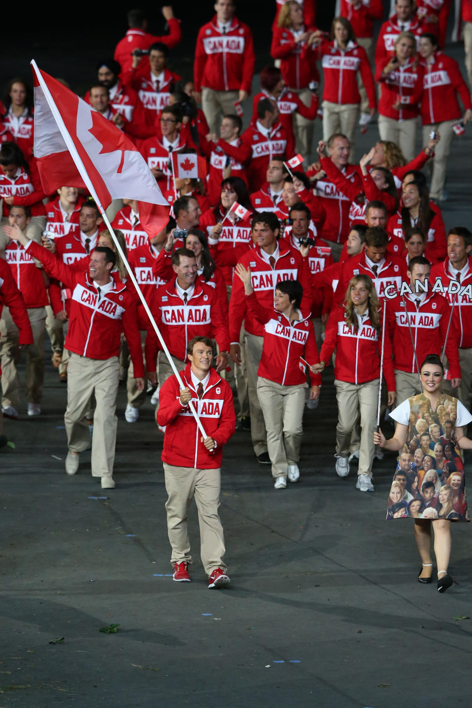 LONDON, ENGLAND - JULY 27: Simon Whitfield of the Canada Olympic triathlon team carries his country's flag during the Opening Ceremony of the London 2012 Olympic Games at the Olympic Stadium on July 27, 2012 in London, England. (Photo by Alex Livesey/Getty Images)