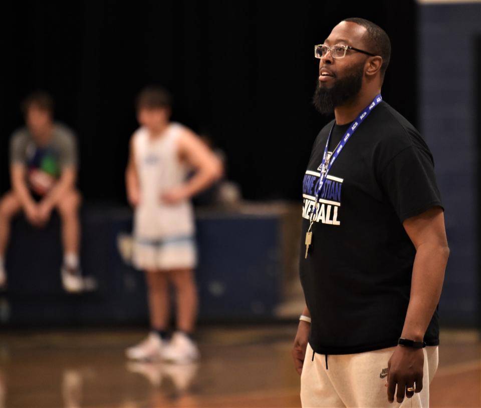 Abilene Christian High coach Kevin Brooks, right, watches his team practice Monday at the ACHS gym.