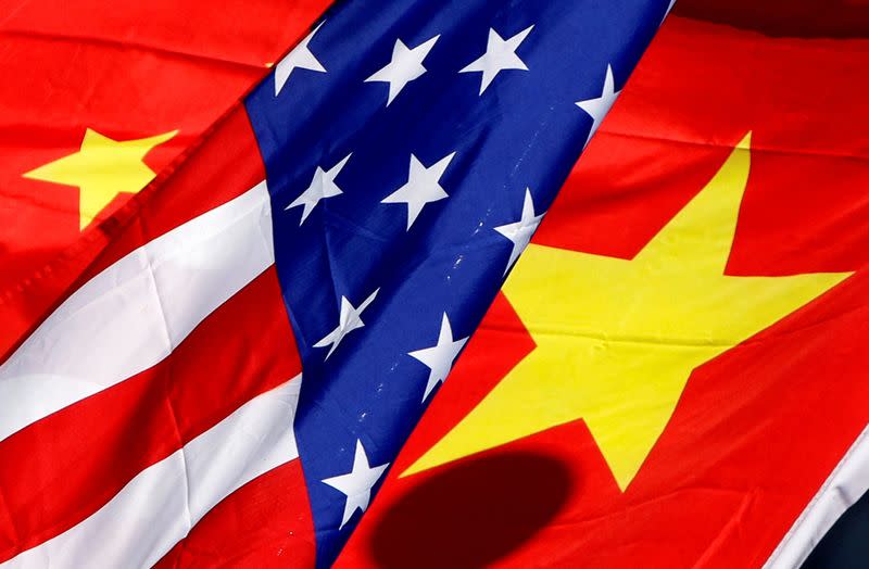 FILE PHOTO: The national flags of the U.S. and China wave in front of an international hotel in Beijing