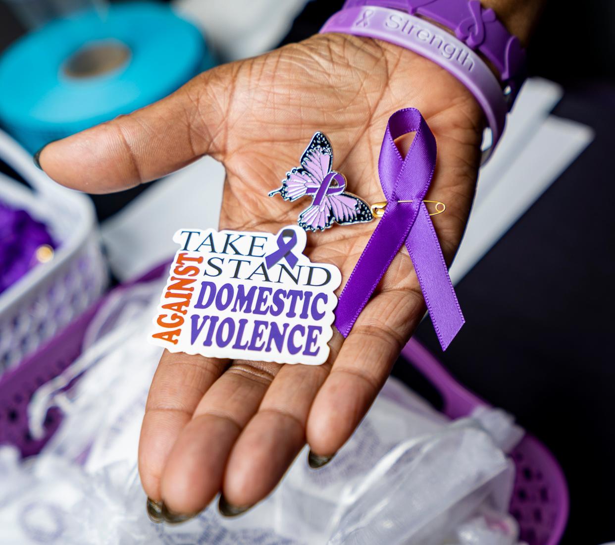 Ribbons, stickers and pins to raise awareness on domestic violence is seen at the Love Without Violence conference hosted by the Milwaukee Office of Community Wellness and Safety on Friday October 20, 2023 in Milwaukee, Wis.