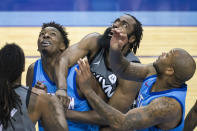 Brooklyn Nets guard James Harden (13) battles for a rebound with Houston Rockets forward Jae'Sean Tate (8) and Houston Rockets forward P.J. Tucker (17) during the first half of an NBA basketball game Wednesday, March 3, 2021, in Houston. (Mark Mulligan/Houston Chronicle via AP)