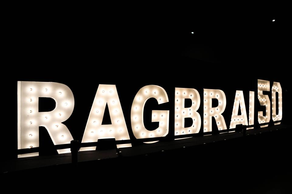 A sign celebrating RAGBRAI 50 lights up Hy-Vee Hall at the RAGBRAI route announcement party Saturday in Des Moines.