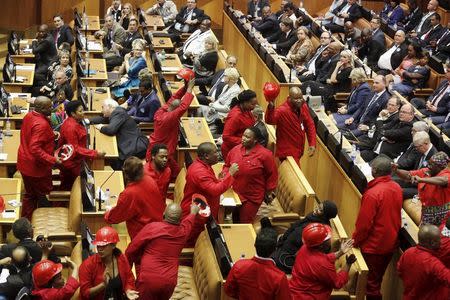 Members of the opposition Economic Freedom Fighters (EFF) party leave the parliamentary chamber as South Africa's President Jacob Zuma delivers his State of the Nation address in Cape Town, February 11, 2016. REUTERS/Schalk van Zuydam/Pool