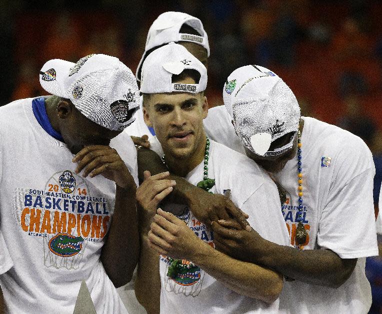 Florida's Scottie Wilbekin (5) celebrates after the second half of an NCAA college basketball game against Kentucky in the Championship round of the Southeastern Conference men's tournament, Sunday, March 16, 2014, in Atlanta. Florida won 61-60.(AP Photo/Steve Helber)