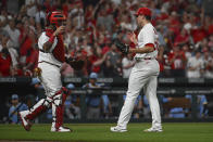 St. Louis Cardinals catcher Yadier Molina, left, and pitcher Ryan Helsley celebrate the Cardinals' 4-1 victory over the Milwaukee Brewers in a baseball game on Wednesday Sept. 14, 2022, in St. Louis. (AP Photo/Joe Puetz)