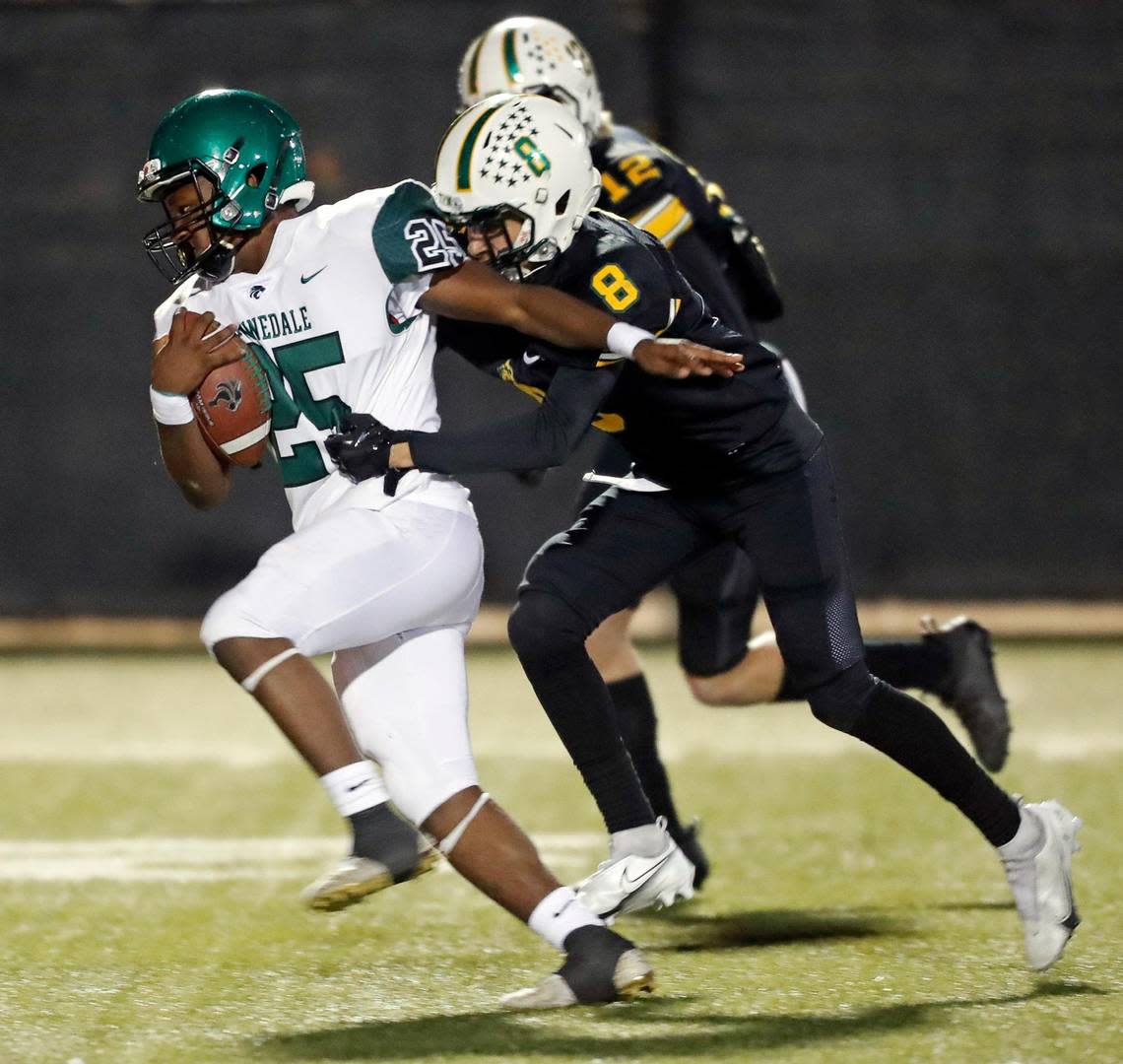 Kennedale running back Jeremiah Clea (25) takes Benbrook defensive backs Eli Guzman (8) and Jake Lindsay (12) downfield for extra yardage in a District 6-4A football game at Handley Field in Fort Worth, Texas, Friday Nov. 05, 2021. Kennedale defeated Benbrook 63-0. (Special to the Star-Telegram Bob Booth) Bob Booth/Bob Booth