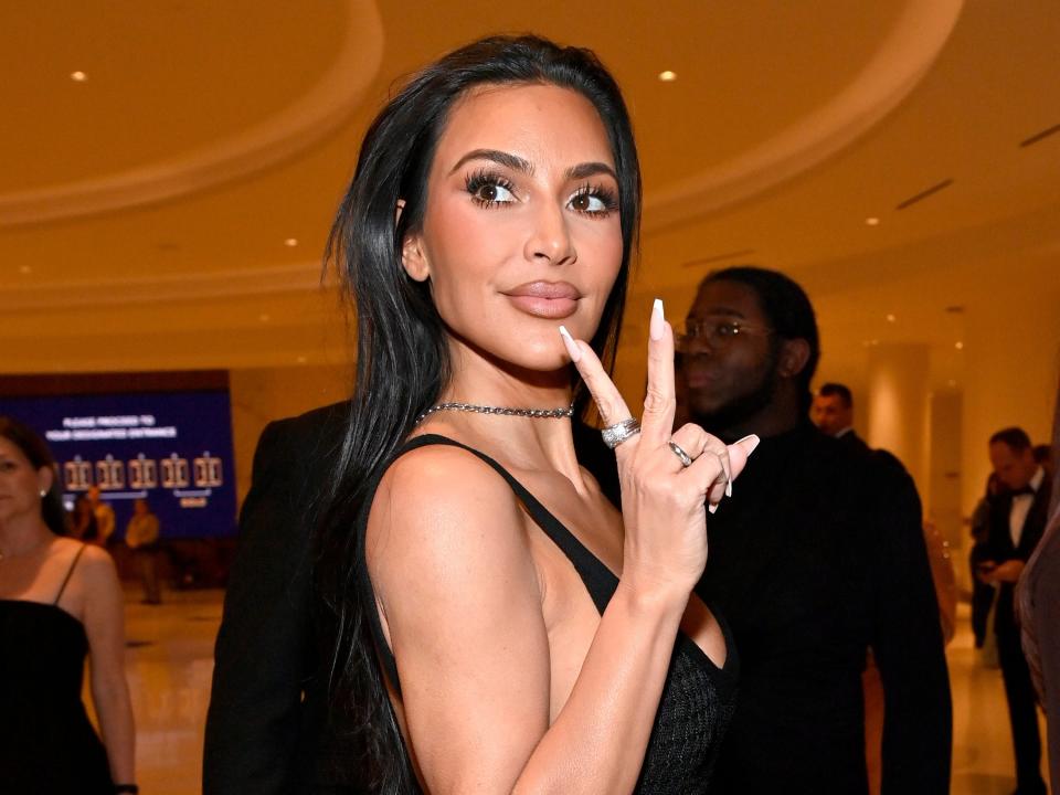 Kim Kardashian flashes a peace sign while at the Fontainebleau Hotel in Las Vegas.