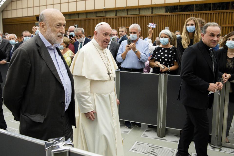 Pope Francis walks next to Carlo Petrini during an audience at the Vatican, Saturday, Sept. 12, 2020. Pope Francis has formed an unusual partnership with the agnostic former communist founder of the Slow Food movement to double down on his calls to protect the environment from profit-driven development that Francis says is harming the poorest most. Francis on Saturday welcomed Carlo Petrini to the Vatican and met with participants of a committee Petrini formed to help put into practice Francis’ appeals for environmental sustainability and solidarity articulated in his 2015 encyclical “Laudato Sii” (Praised Be). (Vatican Media via AP)