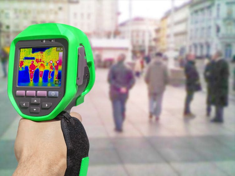 <span class="caption">A thermal camera lets you ‘see’ heat, by picking up thermal radiation.</span> <span class="attribution"><a class="link " href="https://www.shutterstock.com/image-photo/recording-thermal-camera-people-walking-city-530560630?src=nekPl8osuLlV0eLasLYuXA-3-13" rel="nofollow noopener" target="_blank" data-ylk="slk:Shutterstock.;elm:context_link;itc:0;sec:content-canvas">Shutterstock.</a></span>