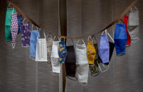 Various face masks are displayed in a shop window in Bad Vilbel near Frankfurt, Germany, Thursday, Sept. 24, 2020. (AP Photo/Michael Probst)