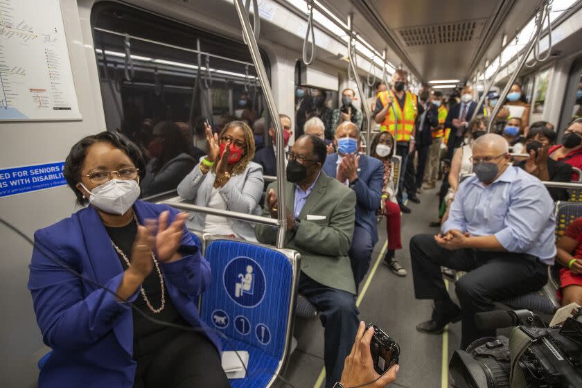 LOS ANGELES, CA -AUGUST 22, 2022:Metro CEO Stephanie Wiggins, left, applauds while riding inside a Metro train traveling on the new K line, as it leaves the Expo/Crenshaw station in Los Angeles, heading to the Westchester/Veterans station in Inglewood, during a test run. Metro's K Line (Crenshaw/LAX Transit Project) will extend light rail from the existing Metro E Line (Expo) at Crenshaw and Exposition Boulevards to the Metro C Line. While the rail line includes 8 new stations, only 7 will be open in the fall of 2022. The train will travel 8.5 miles and will serve the cities of Los Angeles, Inglewood, and El Segundo and portions of unincorporated Los Angeles County. (Mel Melcon / Los Angeles Times)