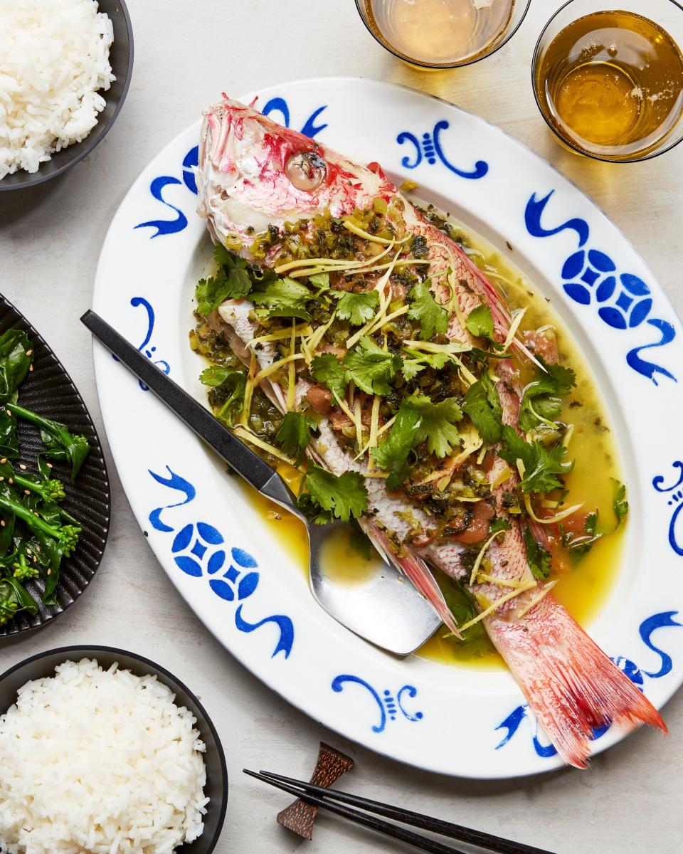 This steamed fish from Diana Zheng is topped with slivered ginger, jarred salted plum, and preserved mustard greens, and drizzled with fish sauce and rice wine.