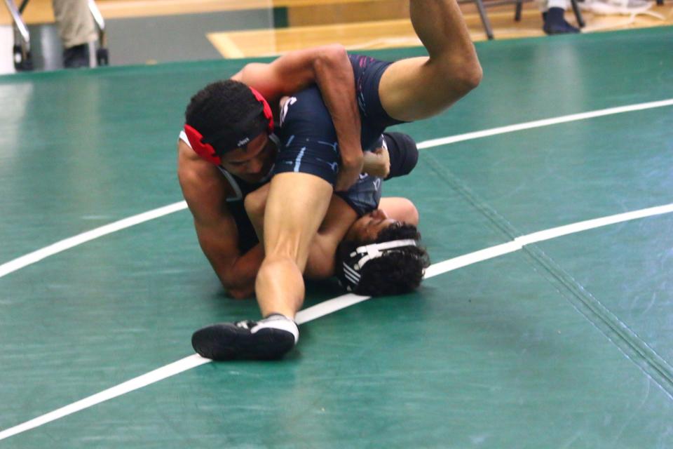 David Collington of Fort Myers High trying to pin his opponent during a match at the Gary Freis Duals held Saturday, Dec. 4 at Fort Myers High School.