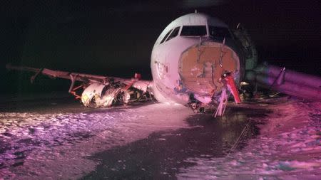 An Air Canada Airbus A320 lies in the snow after it skidded off the runway at Halifax International Airport, Nova Scotia March 29, 2015, in this handout courtesy of the Transportation Safety Board of Canada. The Air Canada Flight 624 crash-landed in the east coast city of Halifax and went off the runway early on Sunday, local media reported, with the airline confirming 23 passengers and crew suffered non-life threatening injuries. REUTERS/Transportation Safety Board of Canada/Handout via Reuters