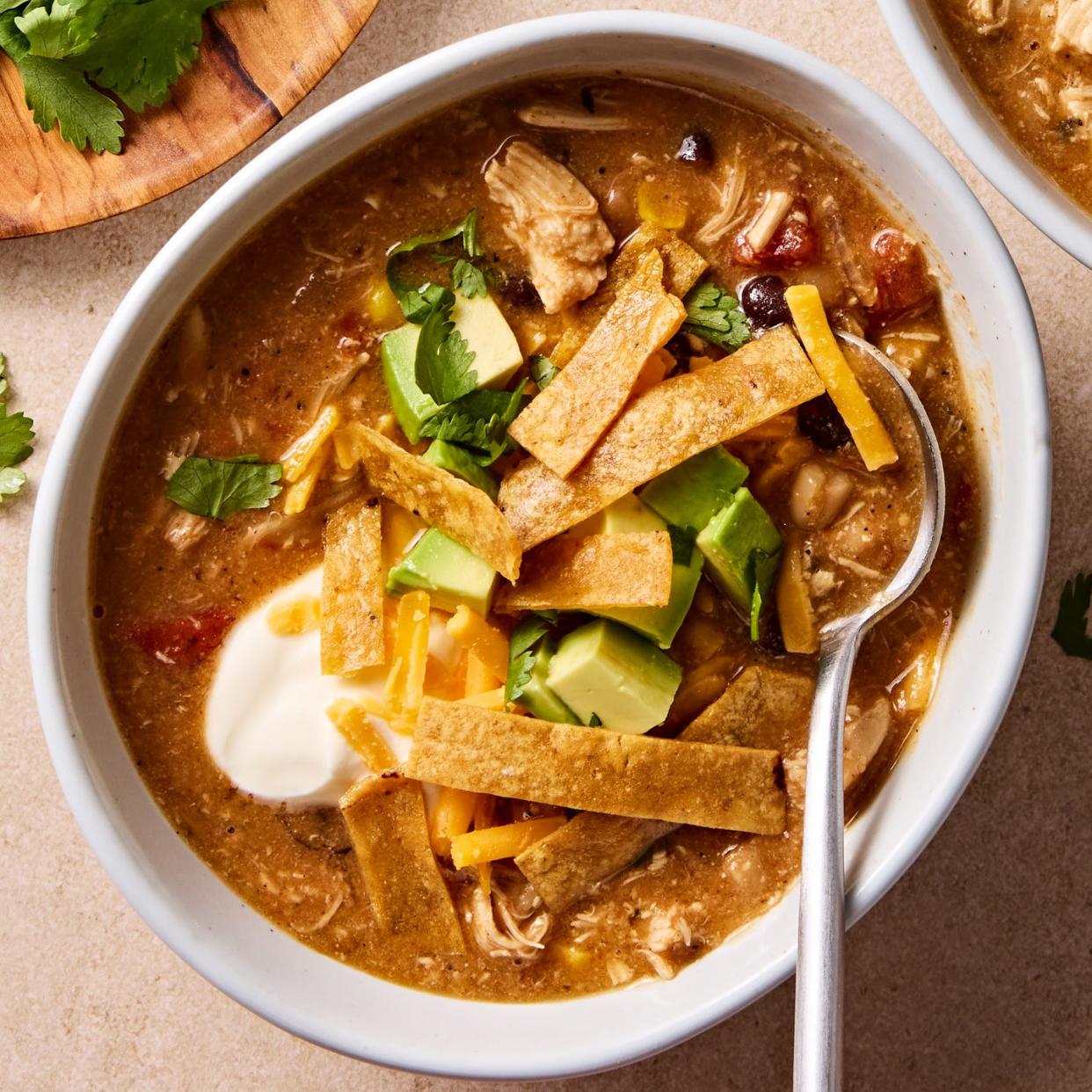 This is a copy of Chick-fil-A's Chicken Tortilla Soup, topped with tortilla strips, cilantro, avocado, and sour cream.