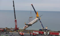 <p>A Pegasus Airlines Boeing 737-800 aircraft, which was skidded off the runway on January 13, 2018, is lifted by a crane at Trabzon airport by the Black Sea in Trabzon, Turkey on Jan. 18, 2018. (Photo: Dogan News Agency/Reuters) </p>