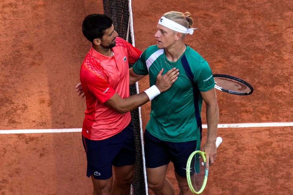 Novak Djokovic is congratulated by Spaniard Alejandro Davidovich Fokina (AP).