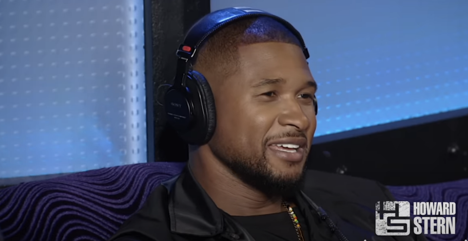 Usher with headphones smiling in a studio, text "Howard Stern" visible in the background