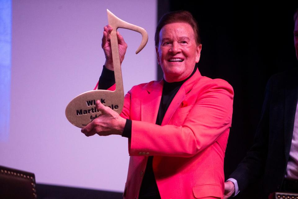 Wink Martindale, a television and radio personality, holds up his Beale Street Brass Note during the “Conversations on Elvis” event at The Guest House at Graceland as part of the Elvis Birthday Celebration in Memphis, Tenn., on Saturday, January 6, 2024.