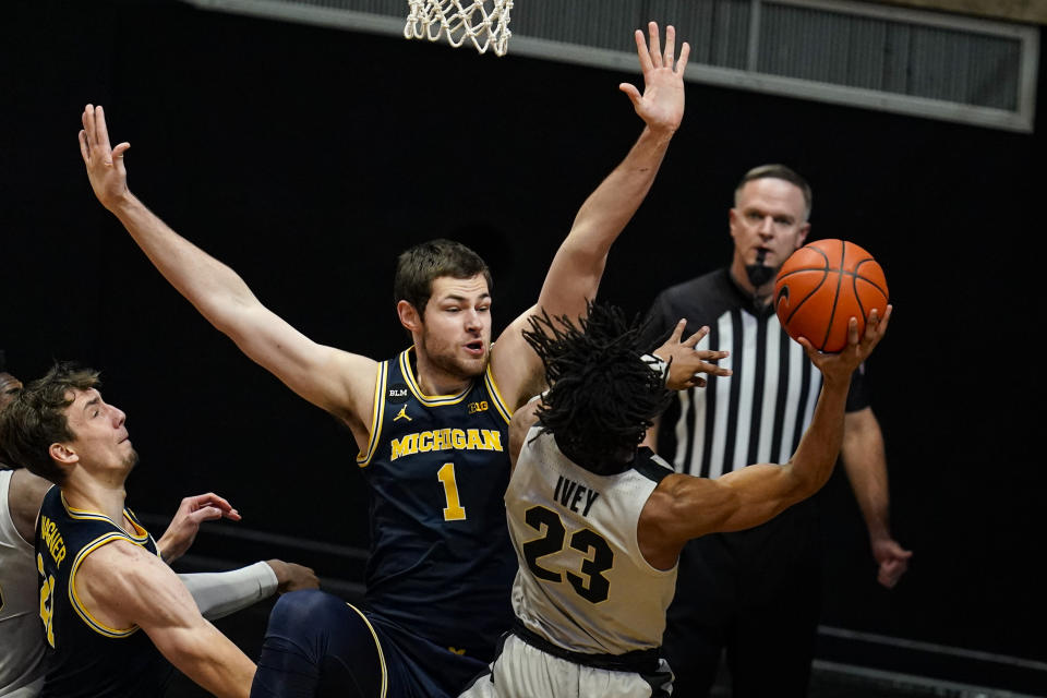 Purdue guard Jaden Ivey (23) shoots over Michigan center Hunter Dickinson (1) during the first half of an NCAA college basketball game in West Lafayette, Ind., Friday, Jan. 22, 2021. (AP Photo/Michael Conroy)