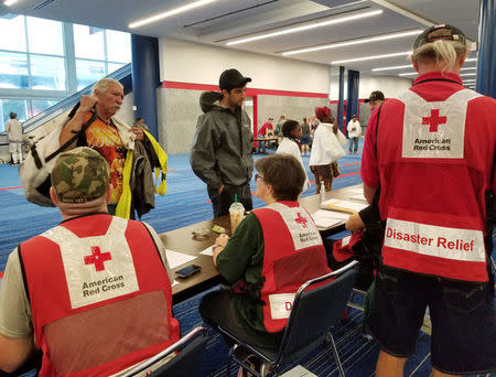 Evacuees arrive to seek shelter with Red Cross volunteers at the George Brown convention center after flood waters of Hurricane Harvey forced them to leave their homes in Houston, Texas, U.S. August 27, 2017. REUTERS/Marianna Parraga