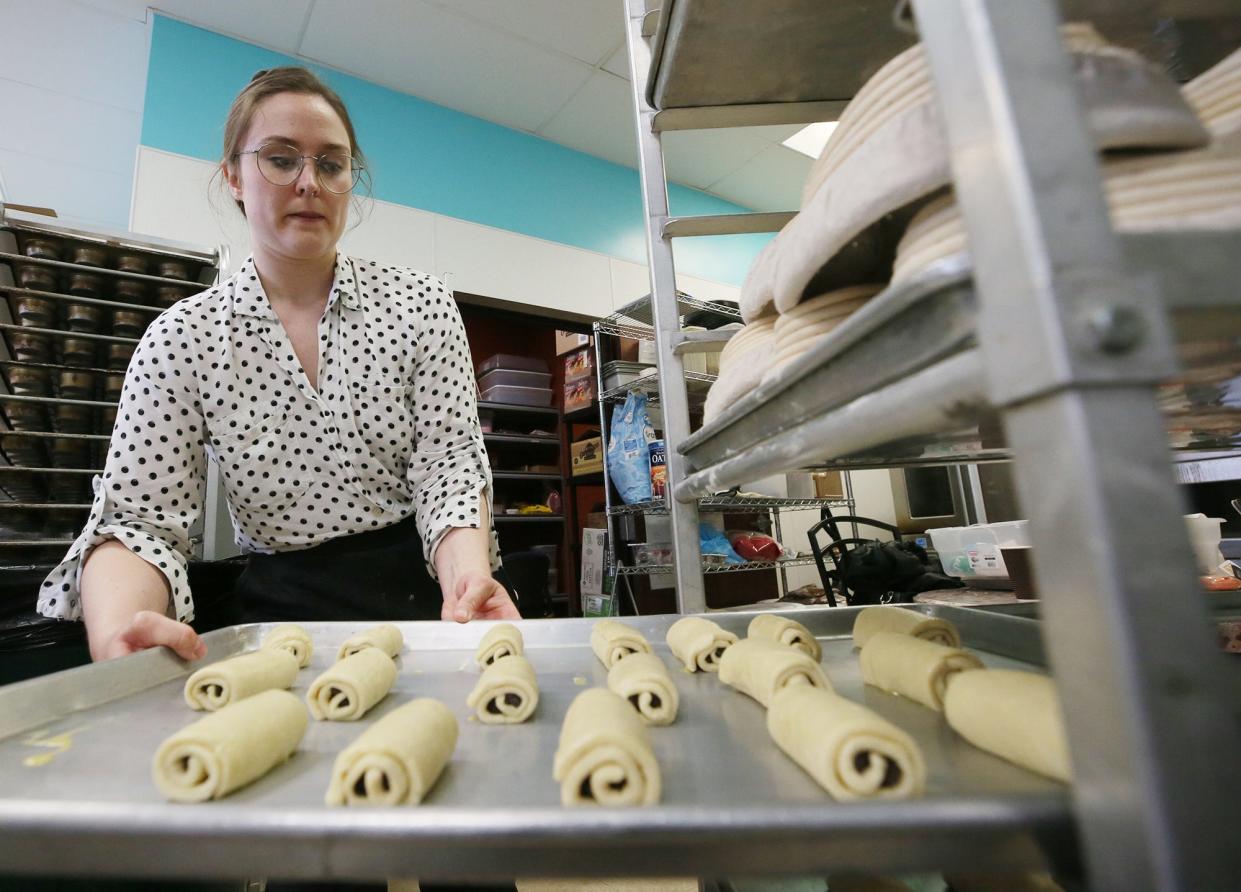 Baker Mary Keim, owner of Scored Artisan Bakery, shows a tray of chocolate-filled croissants that are proofing at Crafty Steere in Fairlawn on Friday, March 15, 2024.