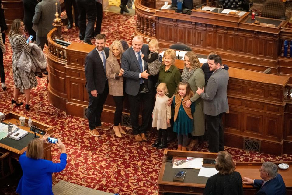 Lawmakers take family photos on the first day of the legislative session, Monday, Jan. 9, 2023.