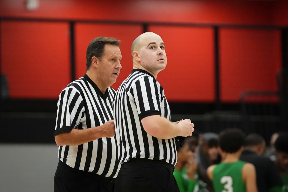 Officials huddle during a boys basketball game between Big Walnut and Dublin Scioto on Jan. 9.