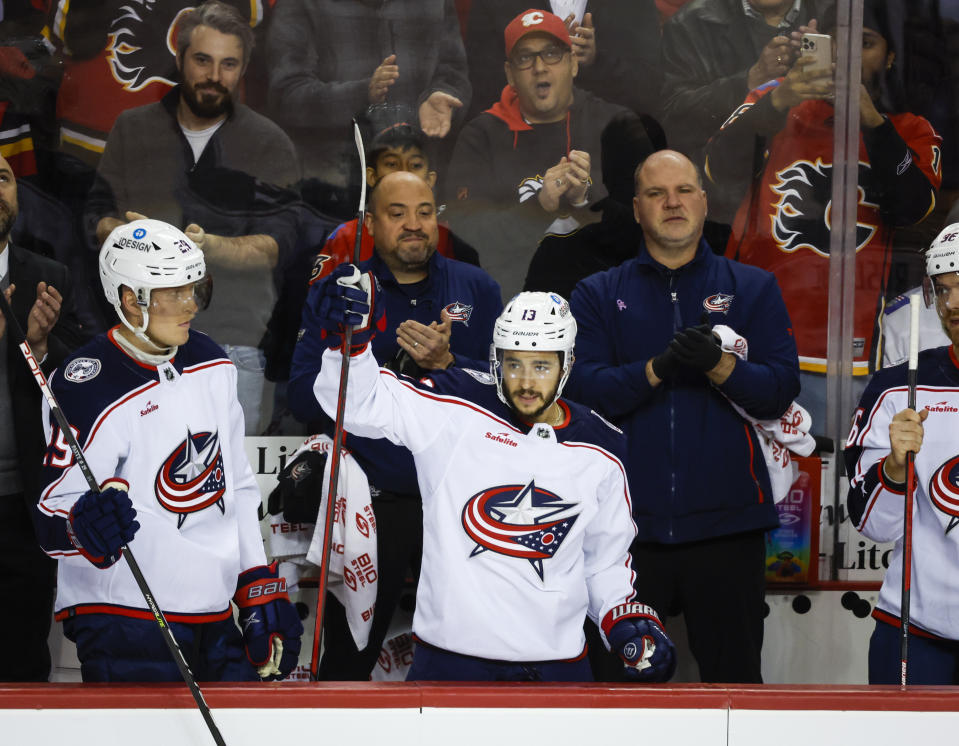 Columbus Blue Jackets forward Johnny Gaudreau (13) waves to fans on his return to Calgary during first-period NHL hockey game action against the Calgary Flames in Calgary, Alberta, Monday, Jan. 23, 2023. (Jeff McIntosh/The Canadian Press via AP)