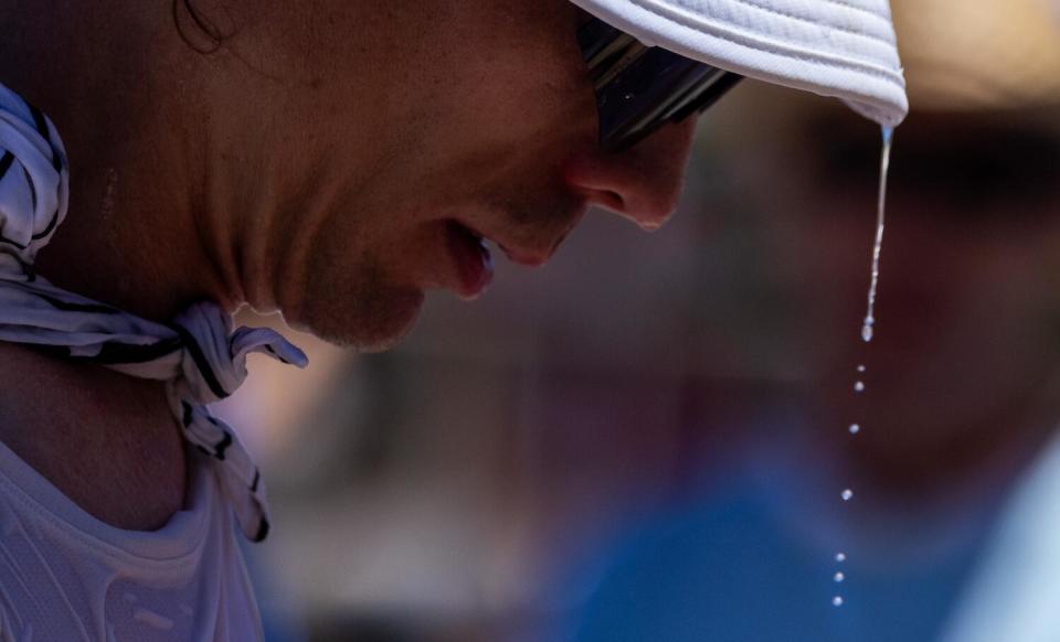 Water drips from front-runner Jim Walmsley's cap during a stop at the Michigan Bluff aid station.