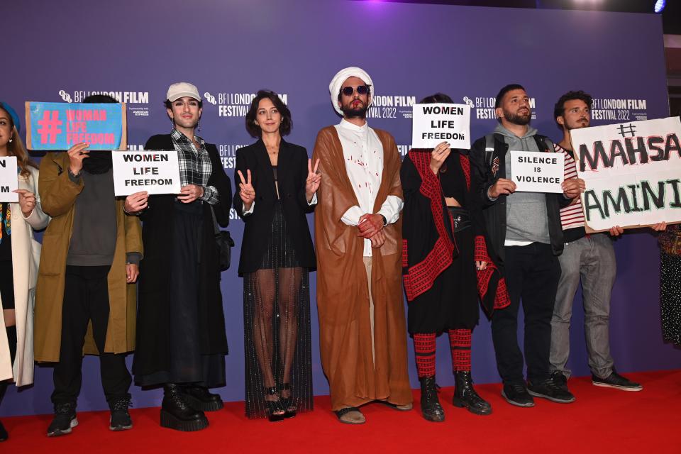 LONDON, ENGLAND - OCTOBER 08: Alongside protesters, Ali Abbasi and Zar Amir Ebrahimi attend the "Holy Spider" UK premiere during the 66th BFI London Film Festival at the Southbank Centre on October 08, 2022 in London, England.