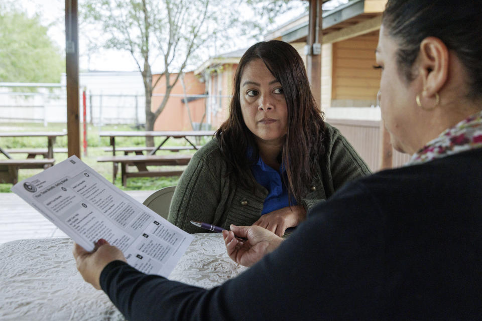 Children's Defense Fund program director Graciela Camarena assists Lucia Salazar with filling out Medicaid and SNAP application forms for her family in Pharr, Texas, Monday, Nov. 13, 2023. As the state reviews Texans' eligibility, some 1 million people have already lost Medicaid and organizations like the one Graciela works for assist people in applying again. (AP Photo/Michael Gonzalez)