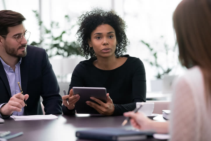 Financial advisors brainstorming creative marketing ideas for their firm.