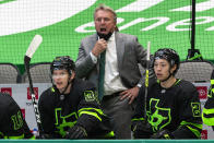 FILE - Dallas Stars coach Rick Bowness gives direction to the team during the second period of an NHL hockey game against the Columbus Blue Jackets in Dallas, in this Saturday, April 17, 2021, file photo. After winning four in a row at home to get within a point of the final playoff spot in the Central Division, the Stars now will end the regular season playing nine of their last 11 games on the road. They will travel to five different cities in that 20-day stretch. "We’ve known all along it was coming,” coach Rick Bowness said. (AP Photo/Sam Hodde, File)