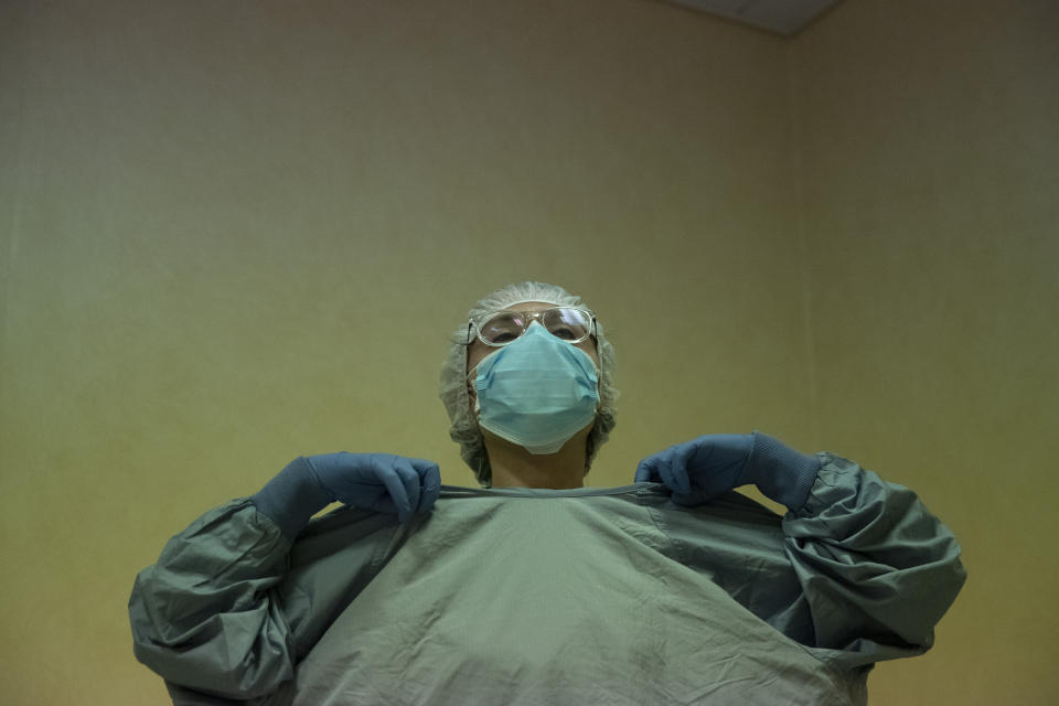 Dr. Elisabetta Teti wears protective gear before starting the second round of medical examinations in a sub-intensive COVID-19 unit of the Tor Vergata Polyclinic Hospital, in Rome, Saturday, Nov. 7, 2020. (AP Photo/Alessandra Tarantino)