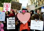 People march holding placards in central Barcelona on January 21, 2017 in a mark of solidarity for the political rally promoting the rights and equality for women, Women's March on Washington, taking place in the US capital