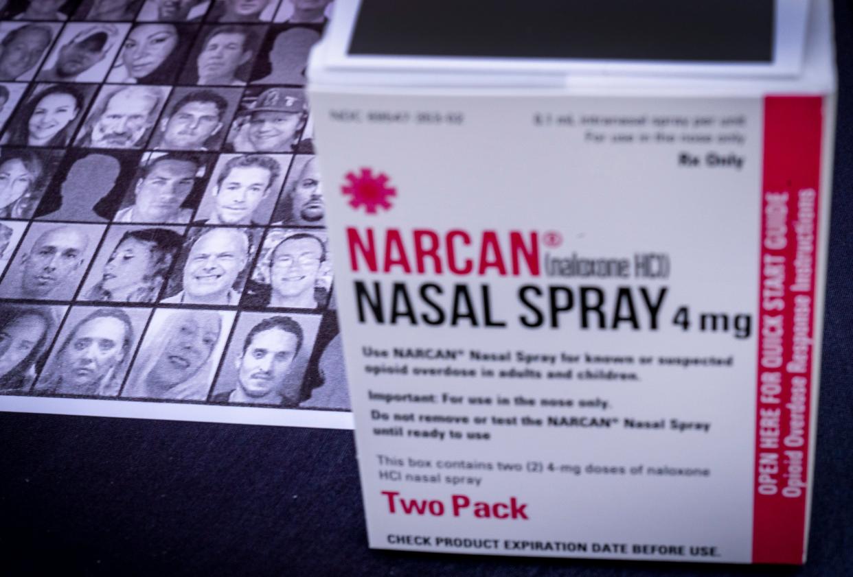 Photographs of lives lost are next to free boxes of Narcan nasal spray that were given away during a rally and candlelight vigil on January, 20, 2022 in Palm Beach Gardens.